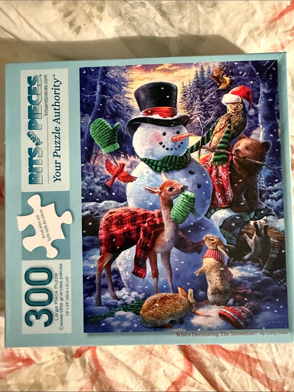 Bits and Pieces 300pc Holiday Puzzle Who’s Decorating the Snowman?By Larry Jones